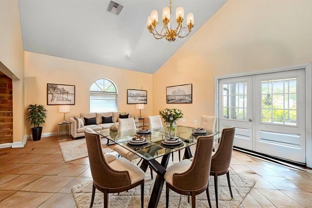 8704 Tarrington Pl, Tampa, FL 33635 - dining room with high vaulted ceiling, a chandelier, light tile patterned floors, and baseboards