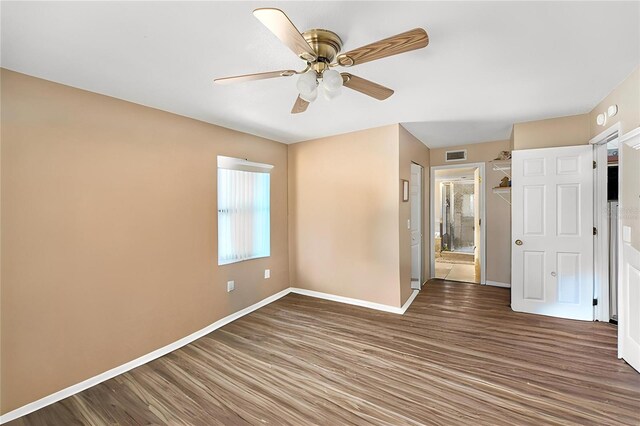 8704 Tarrington Pl, Tampa, FL 33635 - unfurnished bedroom with wood finished floors, baseboards, and a ceiling fan
