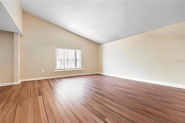 8704 Tarrington Pl, Tampa, FL 33635 - empty room featuring vaulted ceiling, light wood-style floors, and baseboards