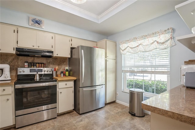kitchen featuring stainless steel appliances, tasteful backsplash, crown molding, under cabinet range hood, and cream cabinets