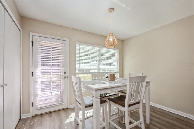 dining room featuring wood finished floors and baseboards