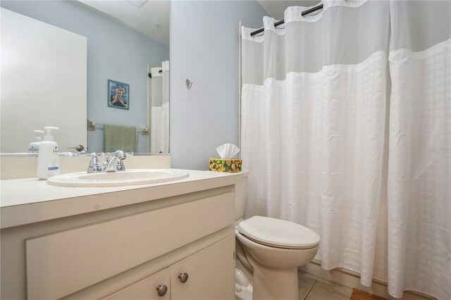 full bathroom with toilet, a shower with shower curtain, vanity, and tile patterned floors