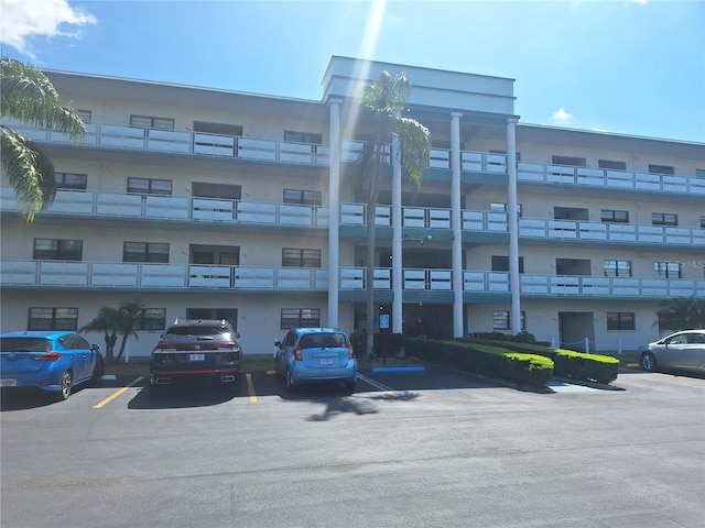 view of building exterior with uncovered parking