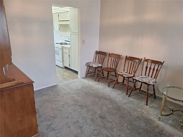 sitting room featuring baseboards and carpet