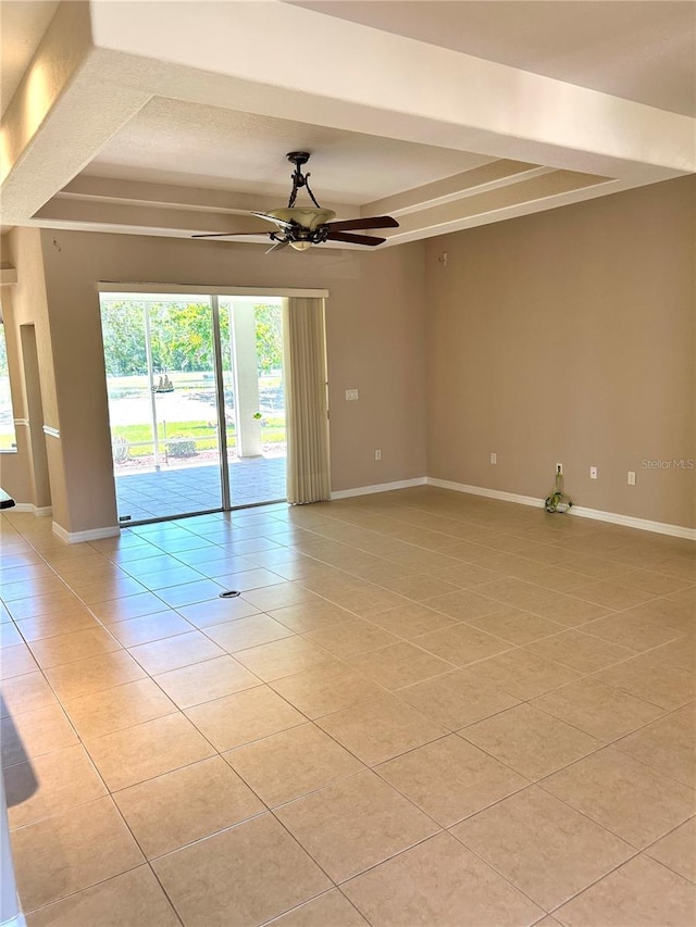 1201 Ventana Dr, Sun City Center, FL 33573 - unfurnished room with baseboards, a tray ceiling, a ceiling fan, and light tile patterned flooring