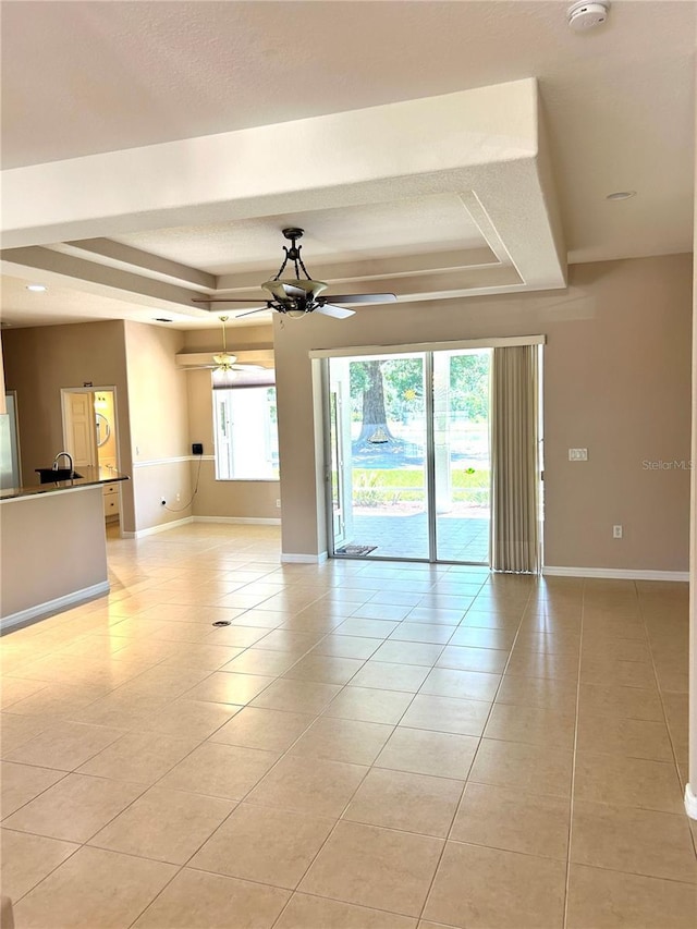 1201 Ventana Dr, Sun City Center, FL 33573 - unfurnished room with light tile patterned flooring, a ceiling fan, and a raised ceiling