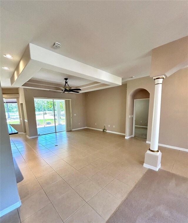 1201 Ventana Dr, Sun City Center, FL 33573 - empty room featuring arched walkways, light tile patterned floors, baseboards, and a ceiling fan