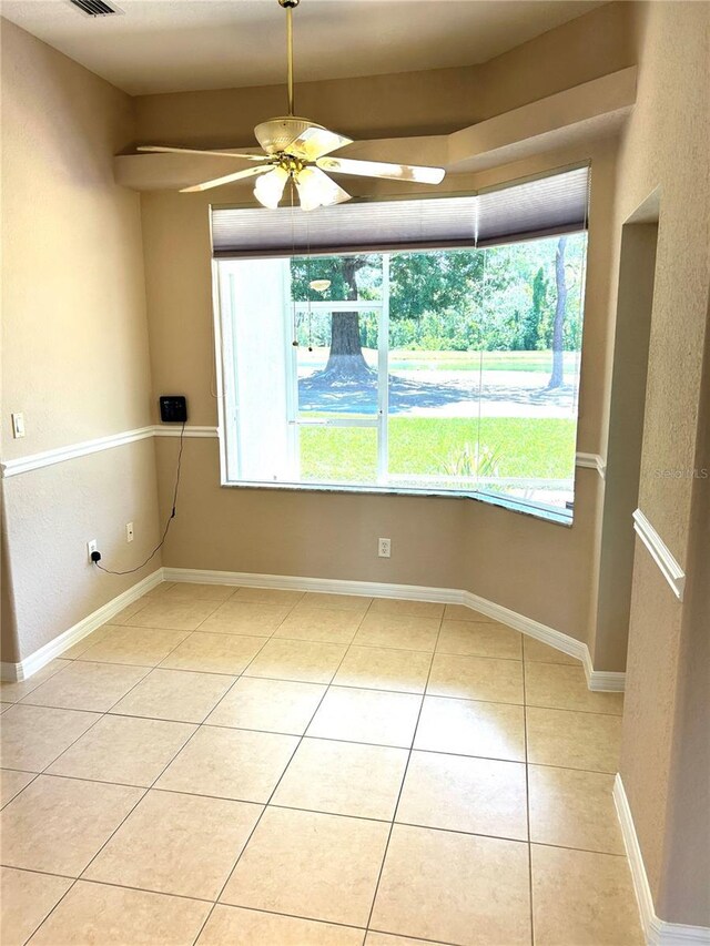 1201 Ventana Dr, Sun City Center, FL 33573 - spare room with plenty of natural light, light tile patterned floors, visible vents, and ceiling fan