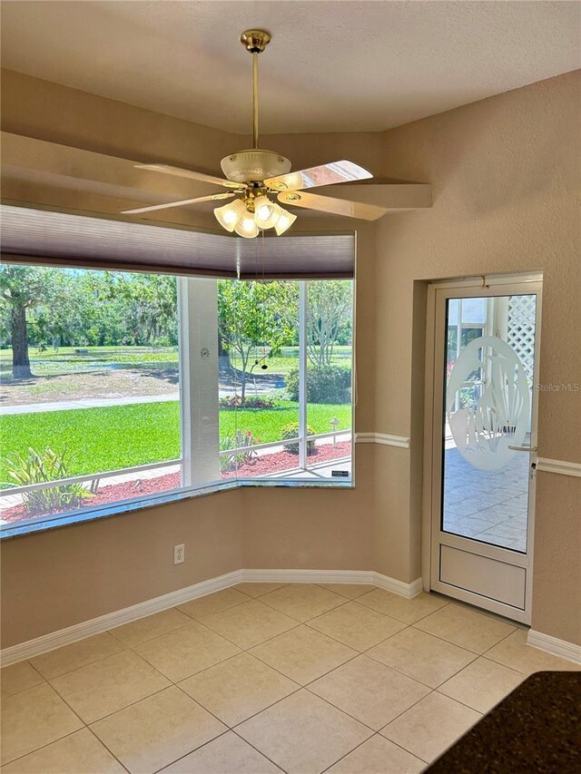 1201 Ventana Dr, Sun City Center, FL 33573 - unfurnished room featuring light tile patterned floors, ceiling fan, and baseboards