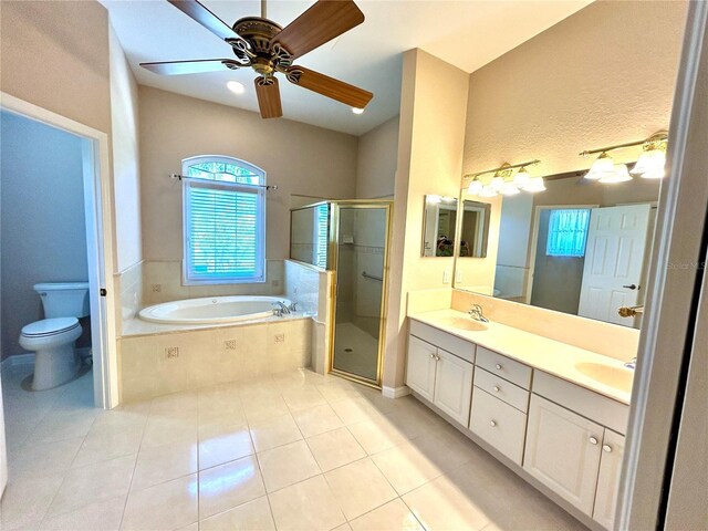 1201 Ventana Dr, Sun City Center, FL 33573 - bathroom featuring a sink, double vanity, a stall shower, toilet, and a garden tub