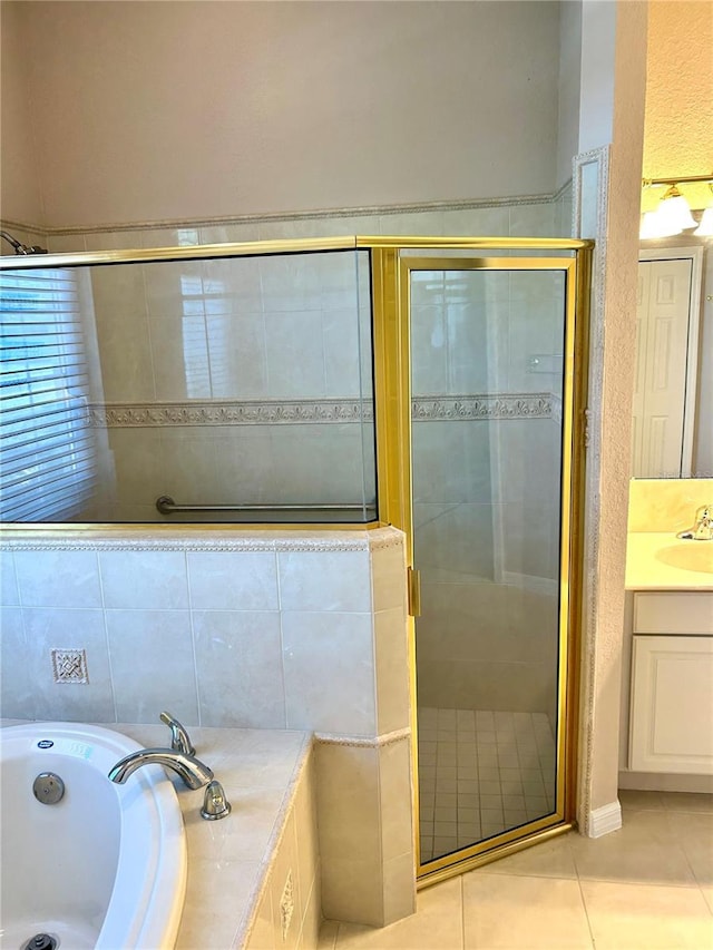1201 Ventana Dr, Sun City Center, FL 33573 - bathroom with a shower stall, tile patterned flooring, vanity, and a bath