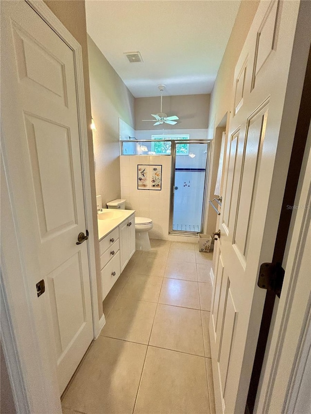 1201 Ventana Dr, Sun City Center, FL 33573 - bathroom featuring visible vents, toilet, ceiling fan, a shower stall, and vanity