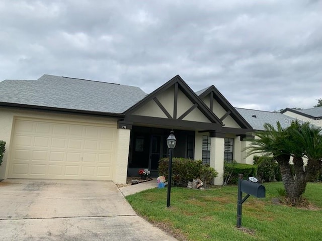 776 Lakewood Dr, Palm Harbor, FL 34684 - ranch-style house with roof with shingles, stucco siding, driveway, an attached garage, and a front yard