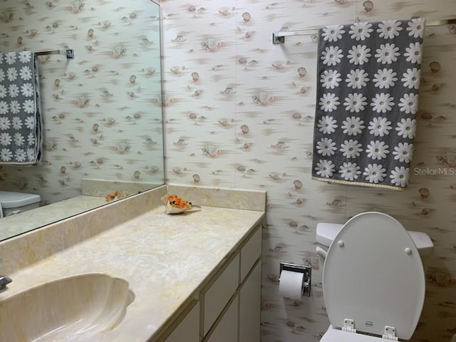 776 Lakewood Dr, Palm Harbor, FL 34684 - half bath featuring toilet, vanity, and wallpapered walls