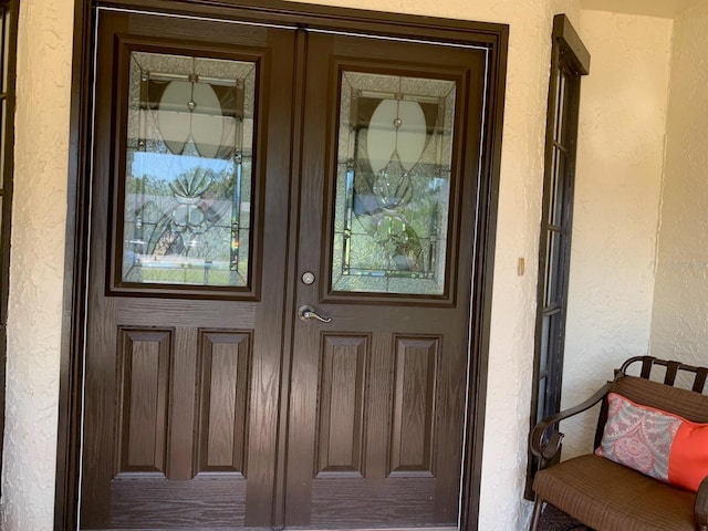 776 Lakewood Dr, Palm Harbor, FL 34684 - doorway to property with stucco siding