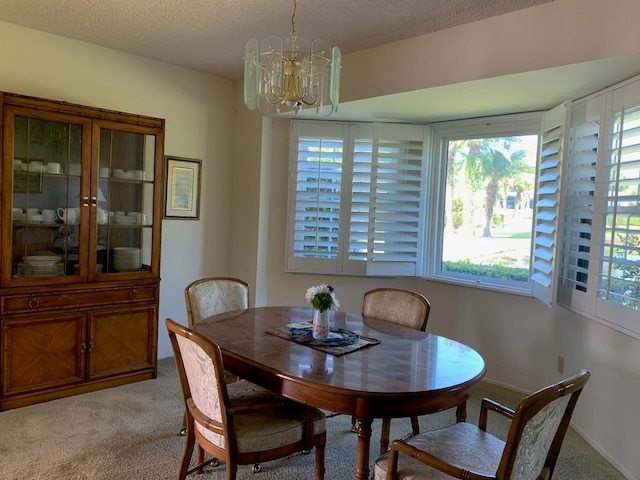 776 Lakewood Dr, Palm Harbor, FL 34684 - dining area featuring light carpet, a notable chandelier, and a textured ceiling