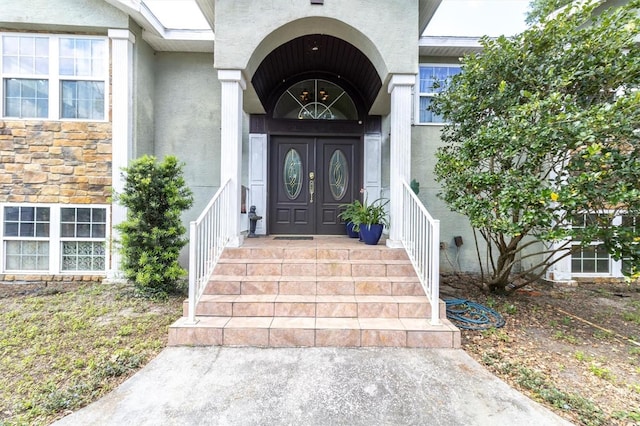 9520 Indale Dr, New Port Richey, FL 34654 - doorway to property with stone siding and stucco siding