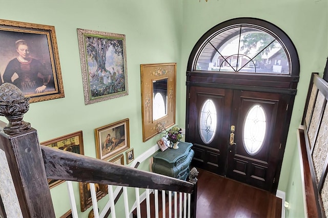 9520 Indale Dr, New Port Richey, FL 34654 - entrance foyer featuring stairs, a towering ceiling, and dark wood-type flooring