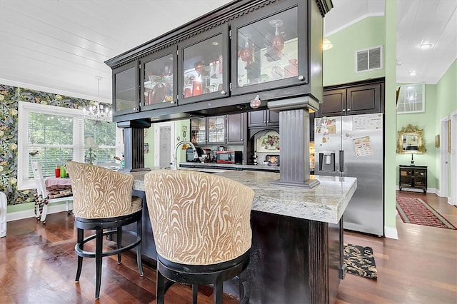 9520 Indale Dr, New Port Richey, FL 34654 - bar featuring ornate columns, visible vents, stainless steel refrigerator with ice dispenser, and baseboards
