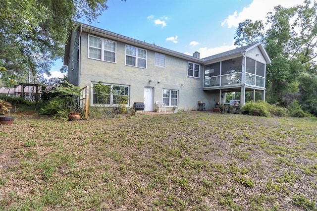 9520 Indale Dr, New Port Richey, FL 34654 - back of property featuring a sunroom and a yard