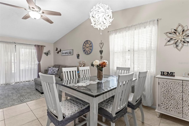 dining room featuring light tile patterned floors, ceiling fan, and lofted ceiling