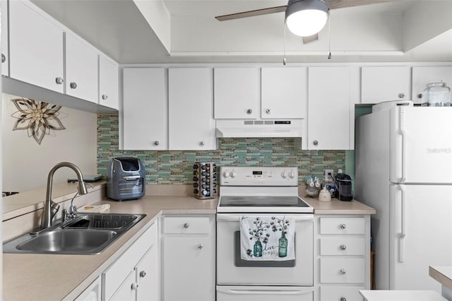 kitchen featuring white cabinets, a sink, light countertops, white appliances, and under cabinet range hood