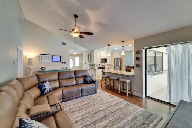 907 Golf Island Dr, Apollo Beach, FL 33572 - living area with lofted ceiling, a ceiling fan, wood finished floors, recessed lighting, and baseboards