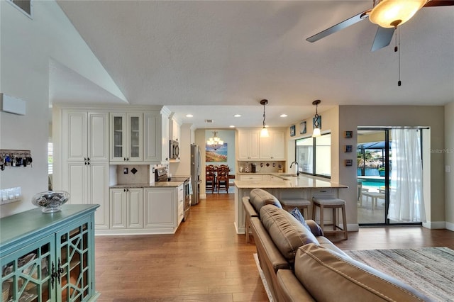 907 Golf Island Dr, Apollo Beach, FL 33572 - living area featuring light wood-style floors, a chandelier, recessed lighting, and ceiling fan
