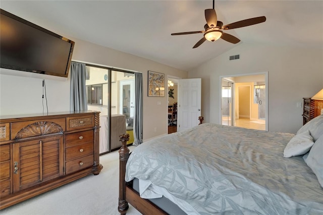 907 Golf Island Dr, Apollo Beach, FL 33572 - bedroom featuring vaulted ceiling, light carpet, ensuite bathroom, and a ceiling fan