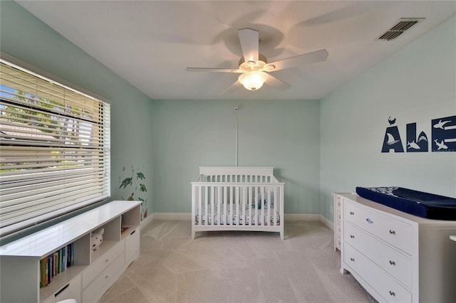 907 Golf Island Dr, Apollo Beach, FL 33572 - bedroom with light colored carpet, baseboards, a ceiling fan, and a nursery area