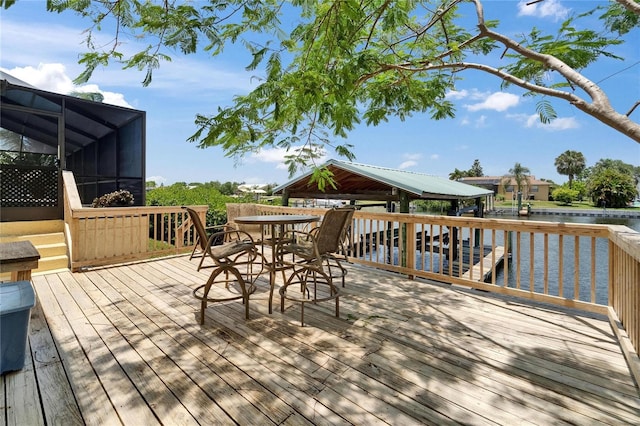 907 Golf Island Dr, Apollo Beach, FL 33572 - wooden deck with a water view, a lanai, a gazebo, and outdoor dining space
