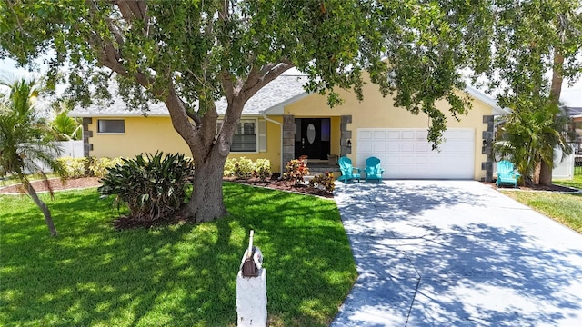 907 Golf Island Dr, Apollo Beach, FL 33572 - view of front facade featuring driveway, stucco siding, an attached garage, and a front yard