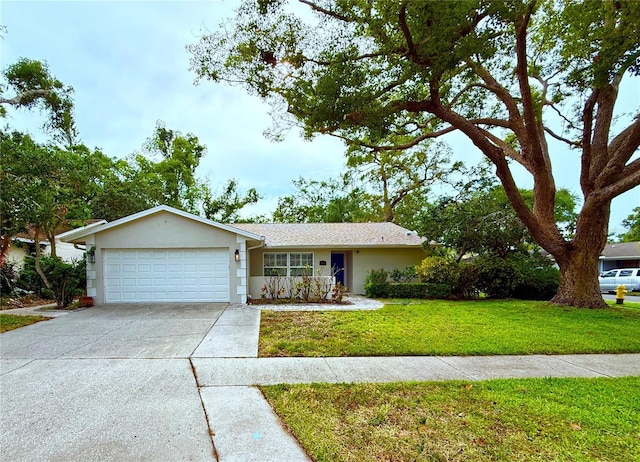ranch-style home with an attached garage, stucco siding, driveway, and a front yard