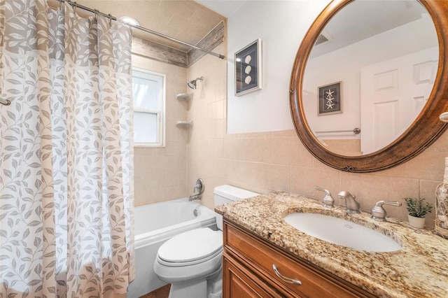 full bath featuring tile walls, toilet, shower / tub combo, and vanity