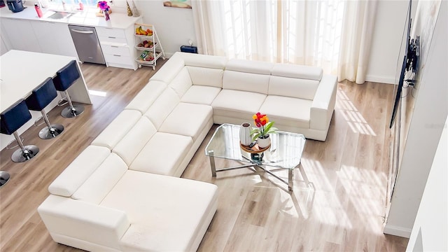 living area with light wood-style floors and baseboards