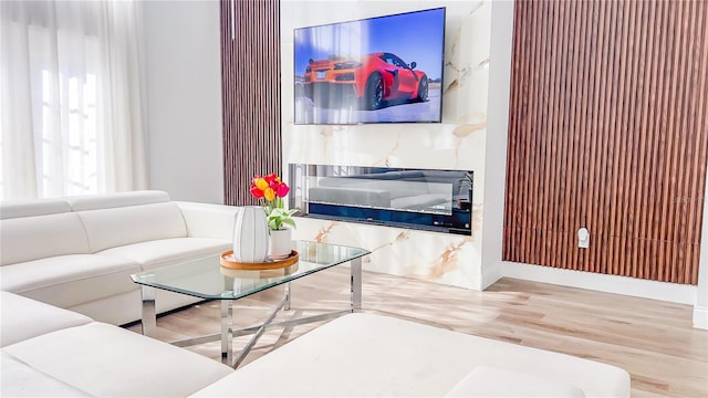 living area featuring baseboards and wood finished floors