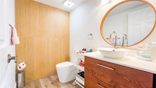 bathroom featuring visible vents, wood finished floors, vanity, and toilet