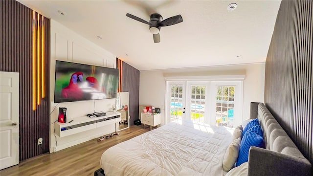 bedroom featuring lofted ceiling, wood finished floors, ceiling fan, and access to exterior