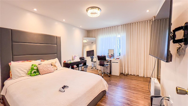 bedroom featuring wood finished floors