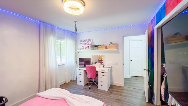 bedroom featuring baseboards and wood finished floors