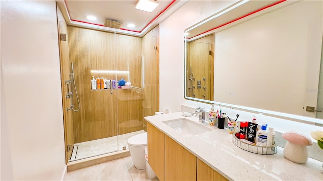 bathroom featuring a shower stall, toilet, vanity, and tile patterned floors