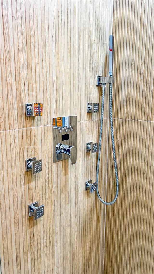 interior details featuring a tile shower