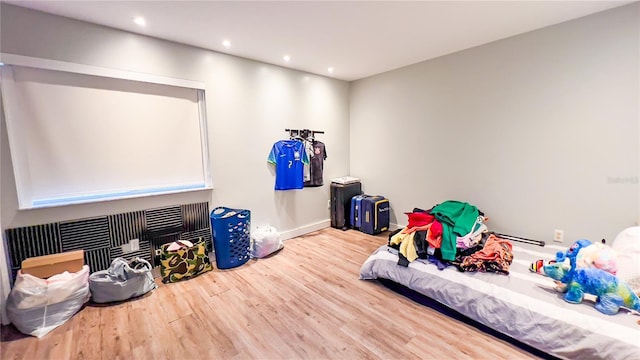 interior space with baseboards, wood finished floors, and recessed lighting