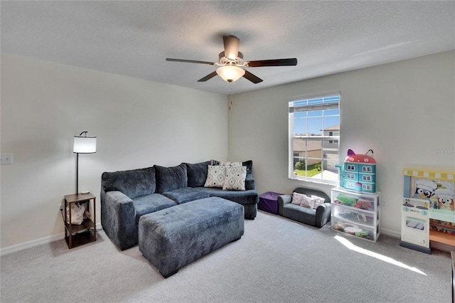 living room featuring carpet flooring, baseboards, and a ceiling fan