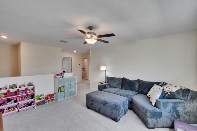 carpeted living area featuring ceiling fan and visible vents