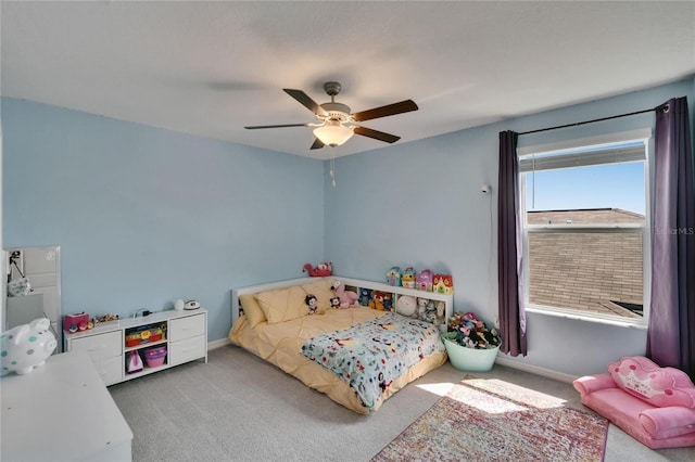 carpeted bedroom with baseboards and ceiling fan