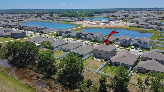 bird's eye view with a water view and a residential view