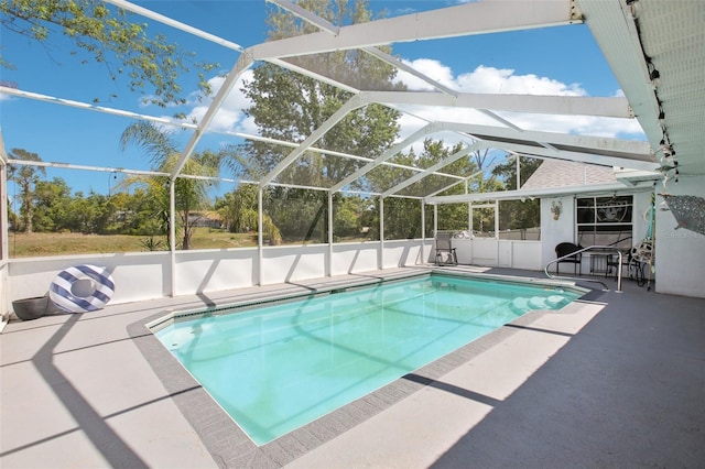 view of swimming pool featuring a patio area, a fenced in pool, and a lanai