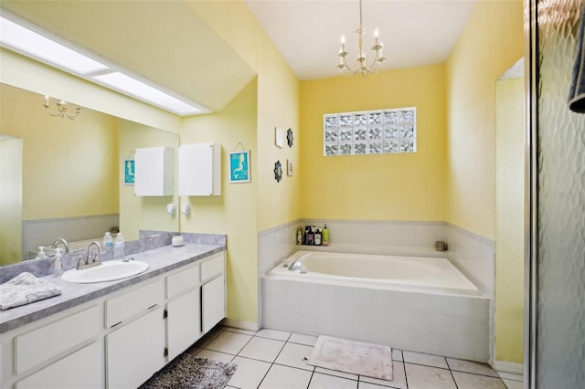 full bathroom featuring a chandelier, a garden tub, tile patterned floors, and vanity