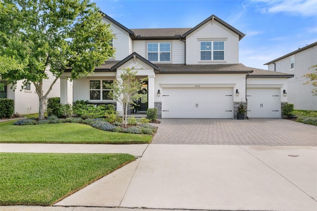4108 Mellon Dr, Odessa, FL 33556 - craftsman inspired home featuring stucco siding, stone siding, a front lawn, and decorative driveway